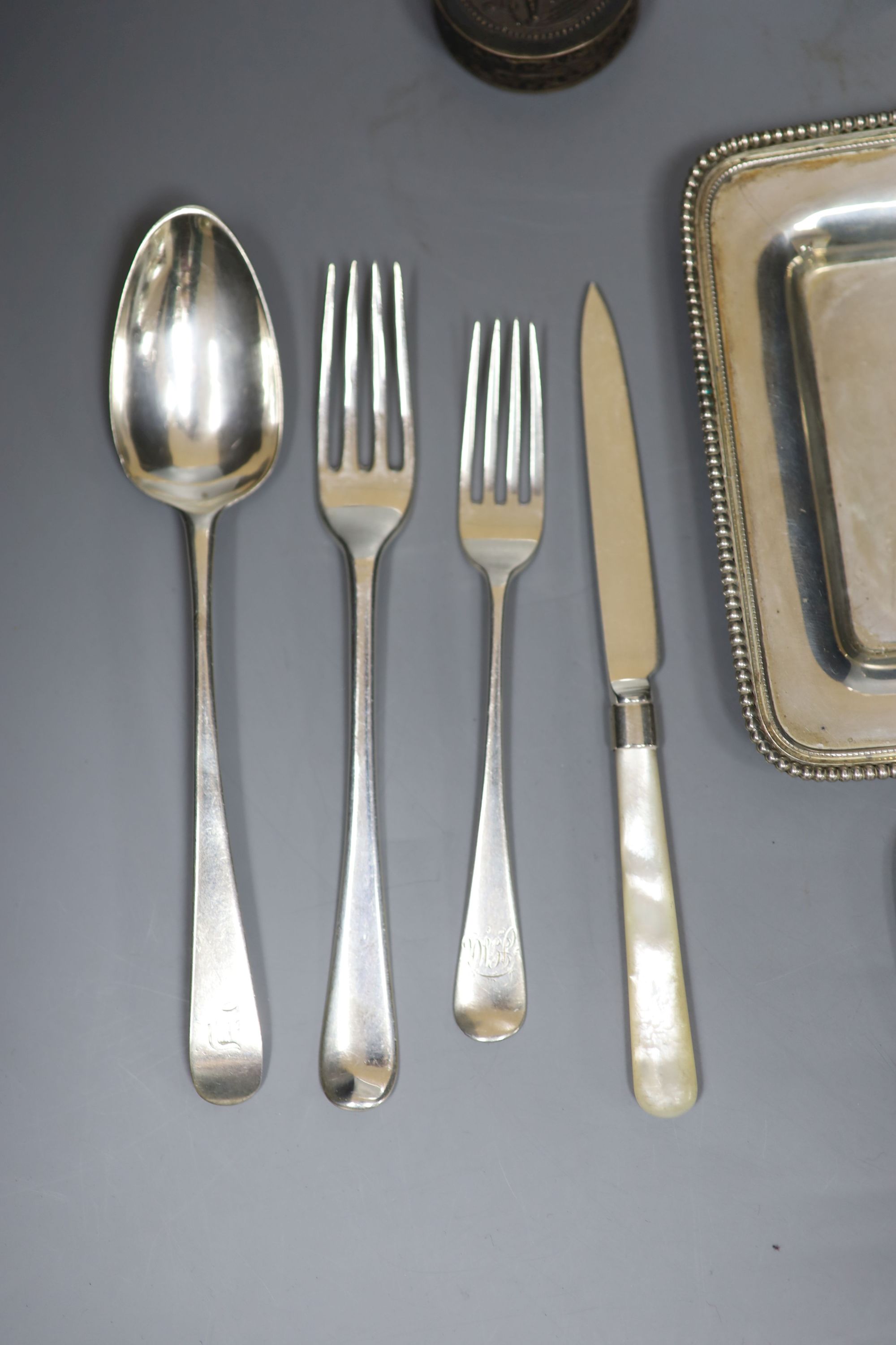 An 800 white metal stand, 16.4cm, twelve items of assorted silver flatware, a silver napkin ring, frame and box.